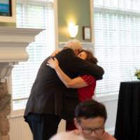Dean Plotkowski hugging retiree